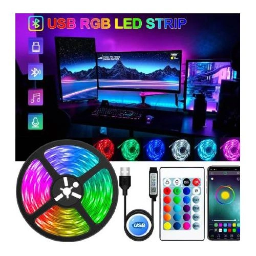 A USB RGB LED strip kit including a remote control and smartphone app interface, shown illuminating a gaming desk with dual monitors.